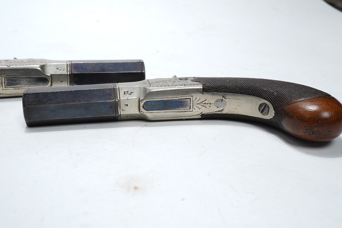 A pair of boxlock percussion pocket pistols with 4cm octagonal barrels, the frames engraved Lacy & Co., London, with London proof marks and rounded chequered walnut butts (2)